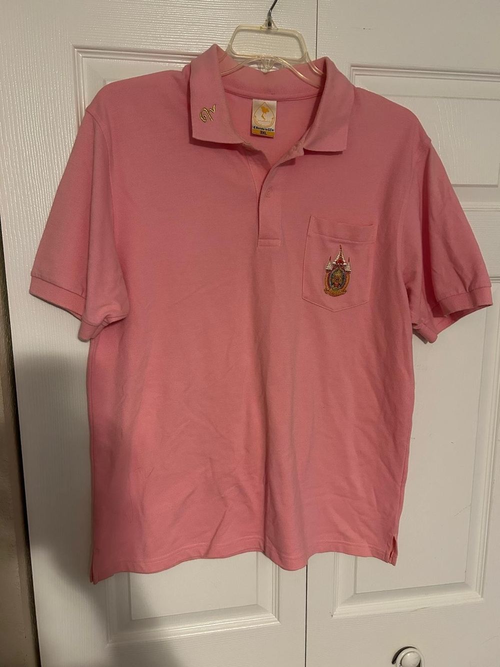 pink, short-sleeve polo shirt that may be associated with Justin Bieber's tour